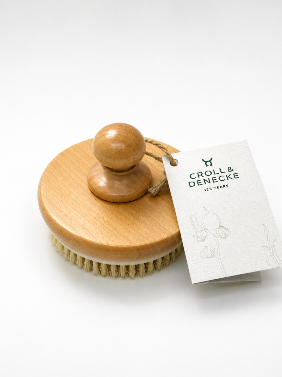 Brosse avec dentures de massage et poignée centrale
